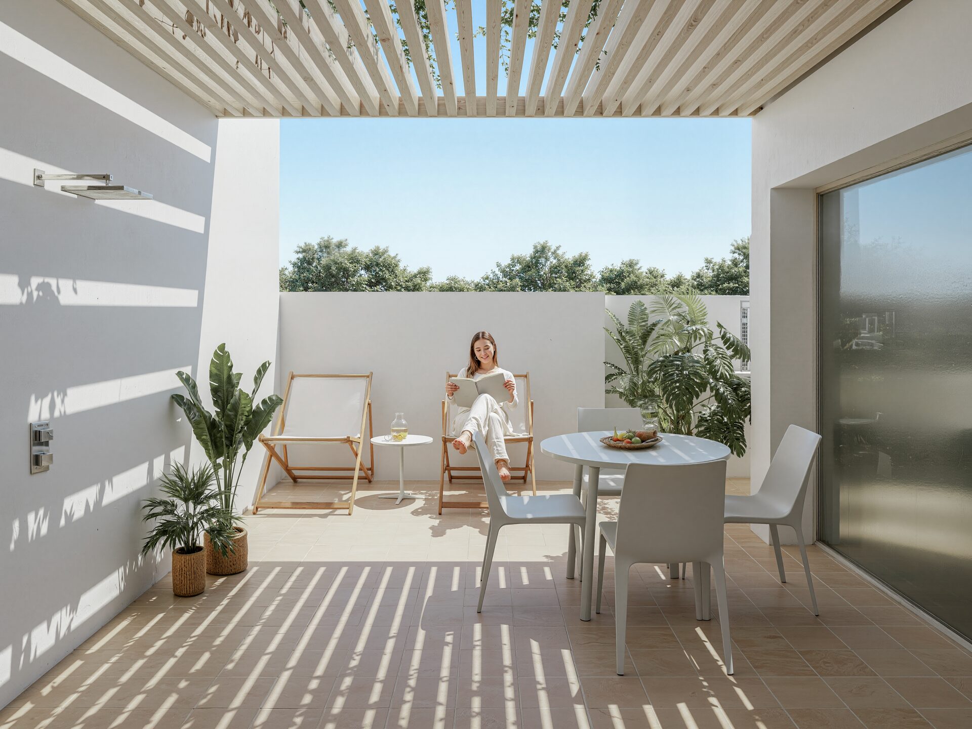 The terrace is protected by a lightweight pergola and sunshades.